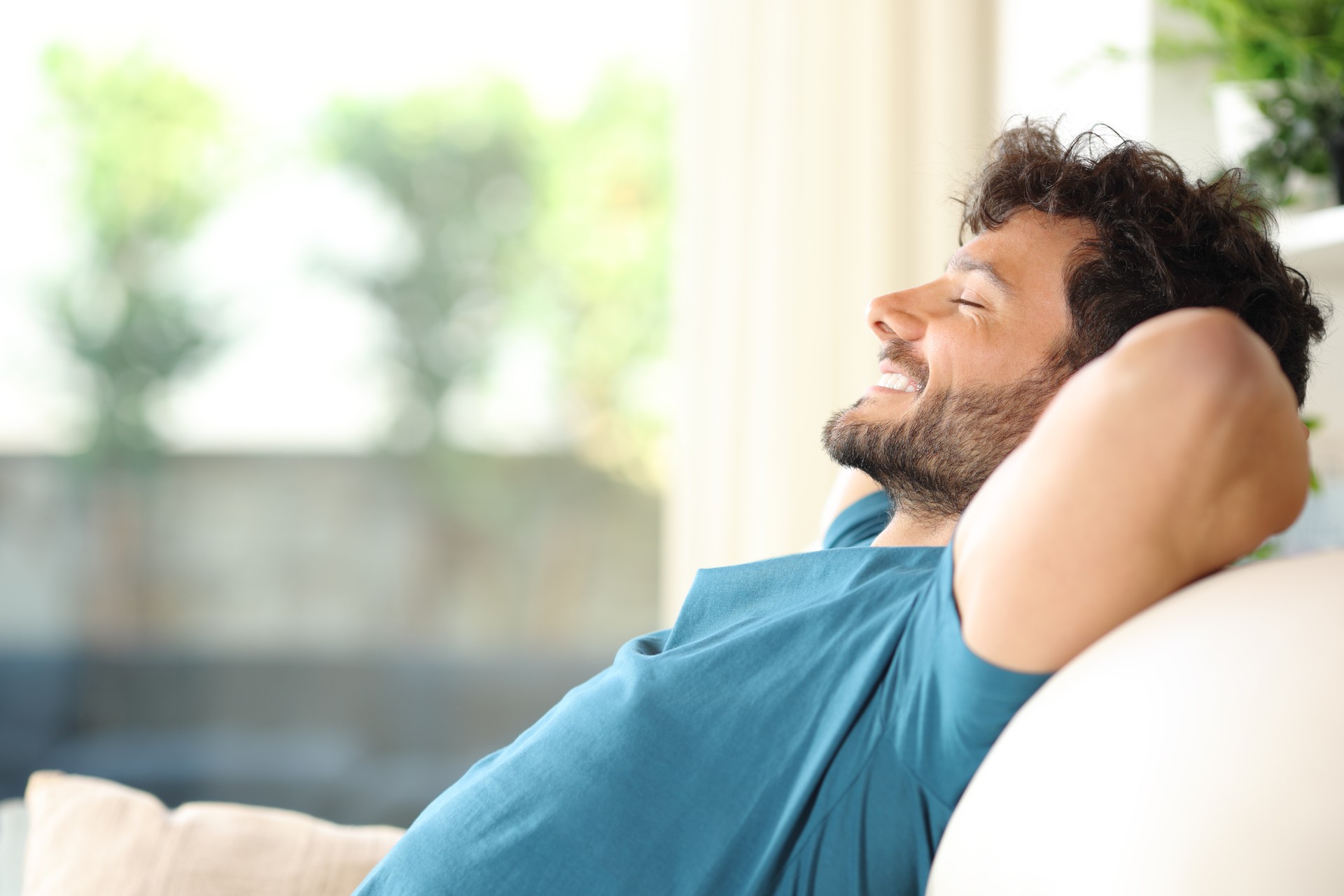 Happy handsome man resting and relaxing at home